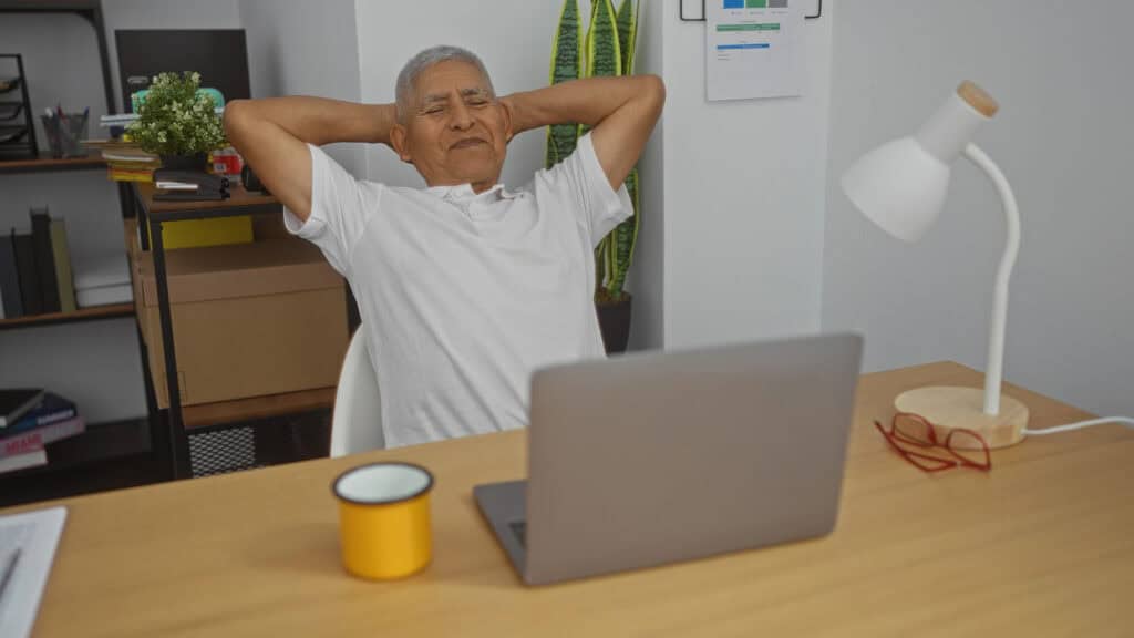 man relaxed sitting at a laptop